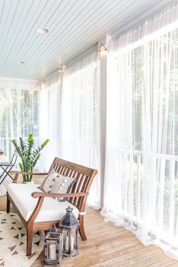 white mosquito netting surrounding covered porch