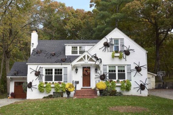 White House with large spiders hung all over the exterior